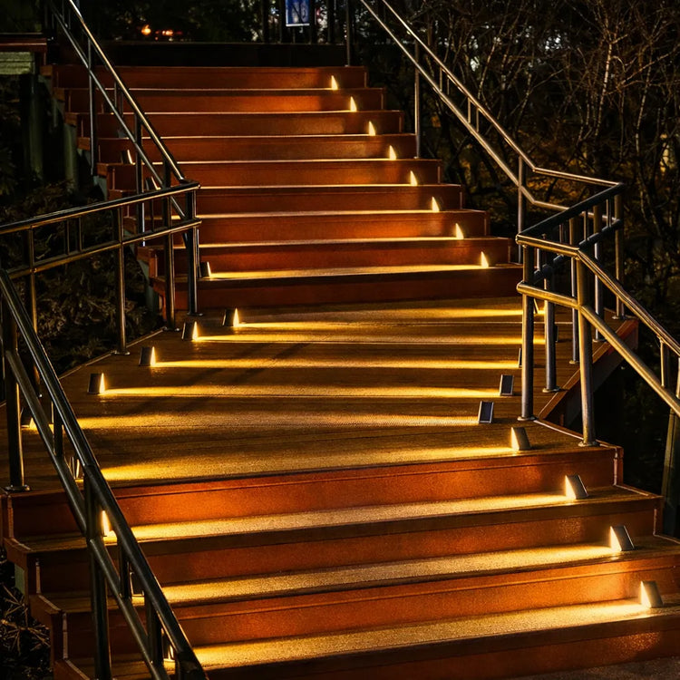 Solar LED step lights built into timber outdoor staircase with warm glow at night, solar stair riser lights for decks and outdoor stairs in Australian homes